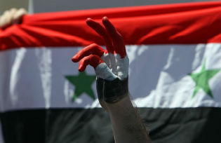 Syrian protester making the victory sign