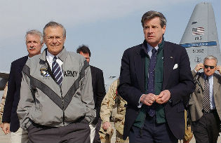 Donald H. Rumsfeld is accompanied by former US Ambassador to Iraq  L. Paul Bremer III at Baghdad International Airport, during Operation Iraqi Freedom.