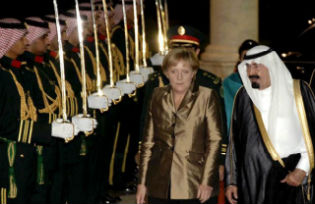 Saudi Arabia’s King Abdullah welcomes German Chancellor Angela Merkel on her arrival at the Royal Palace in Jeddah