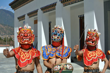 Actors wearing traditional Bhutanese masks - © Aaron Carpené