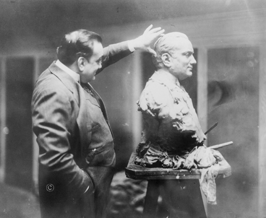 Caruso examining a bust sculpture of himself in 1914