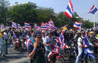 Anti-government protesters in Bangkok on motorcycles while mobilizing to surround government offices 1 December 2013