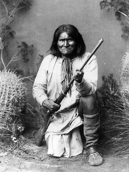 Photograph of Geronimo kneeling with his rifle, taken in 1887 by Ben Wittick (1845–1903)