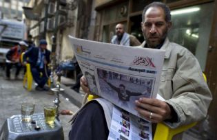Man reading a newspaper in Cairo
